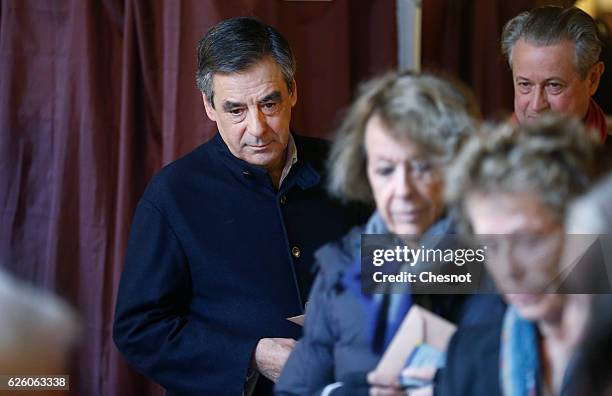 Former French Prime Minister and presidential candidate hopeful Francois Fillon looks on before casts his ballot during the second round of voting in...