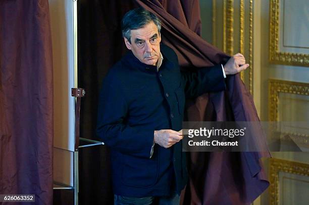 Former French Prime Minister and presidential candidate hopeful Francois Fillon walks out out the voting booth during the second round of voting in...