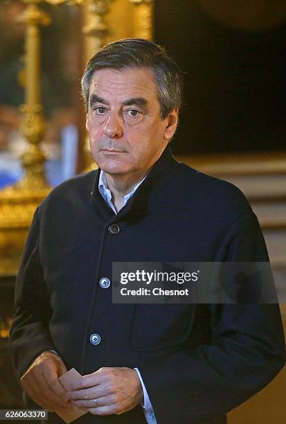 Former French Prime Minister and presidential candidate hopeful Francois Fillon looks on before casts his ballot during the second round of voting in...