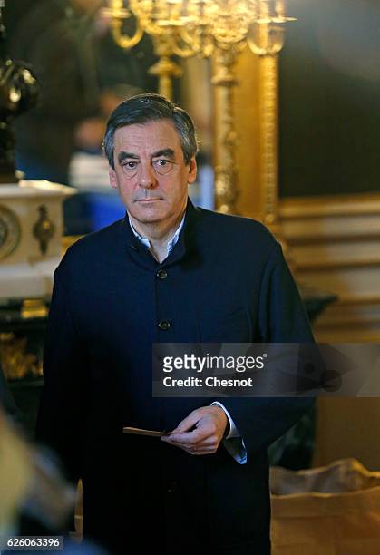 Former French Prime Minister and presidential candidate hopeful Francois Fillon looks on before casts his ballot during the second round of voting in...
