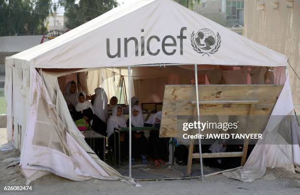 Afghan schoolgirls study in a UNICEF tent used as a classroom in Kandahar province on November 27, 2016.