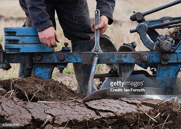 Competitor makes adjustments to his plough as he takes part in the annual ploughing match on November 27, 2016 in Staithes, United Kingdom. The event...