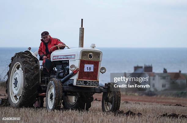 James Jobson from Hartlepool drives his David Brown 990 tractor as he takes part in the annual ploughing match on November 27, 2016 in Staithes,...