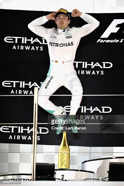 Nico Rosberg of Germany and Mercedes GP celebrates finishing second on the podium and winning the World Drivers Championship during the Abu Dhabi...