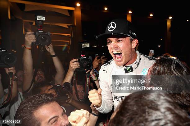 Nico Rosberg of Germany and Mercedes GP celebrates in the Paddock after winning the World Drivers Championship during the Abu Dhabi Formula One Grand...