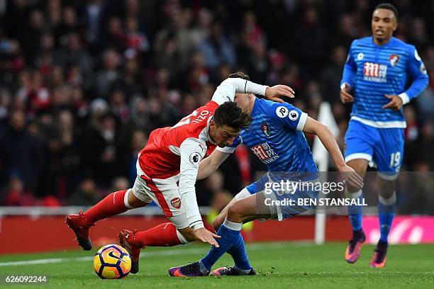 Arsenal's German midfielder Mesut Ozil vies with Bournemouth's Australian midfielder Brad Smith during the English Premier League football match...