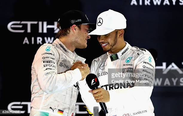 Race winner Lewis Hamilton of Great Britain and Mercedes GP congratulates second place finisher and World Drivers Champion Nico Rosberg of Germany...