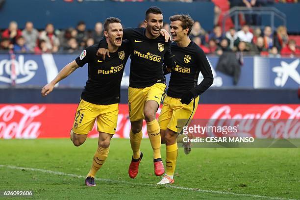 Atletico Madrid's French forward Kevin Gameiro celebrates with Atletico Madrid's Argentinian midfielder Angel Correa and Atletico Madrid's French...