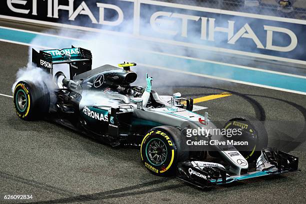 Nico Rosberg of Germany and Mercedes GP celebrates after finishing second and winning the World Drivers Championship during the Abu Dhabi Formula One...