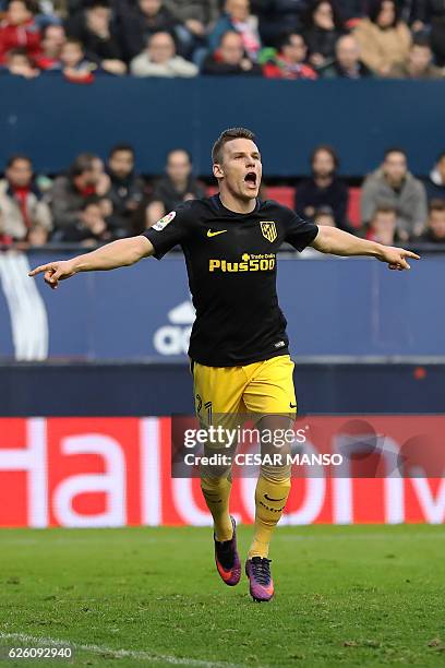 Atletico Madrid's French forward Kevin Gameiro celebrates after scoring during the Spanish league football match CA Osasuna vs Club Atletico de...