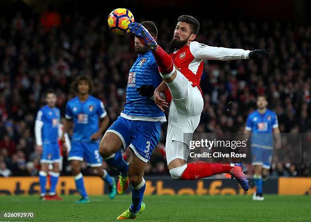 Steve Cook of AFC Bournemouth and Olivier Giroud of Arsenal battle for possession during the Premier League match between Arsenal and AFC Bournemouth...