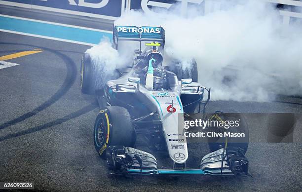 Nico Rosberg of Germany and Mercedes GP celebrates after finishing second and winning the World Drivers Championship during the Abu Dhabi Formula One...