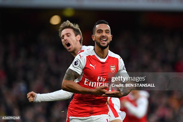 Arsenal's English midfielder Theo Walcott celebrates with Arsenal's Spanish defender Nacho Monreal after scoring their second goal during the English...