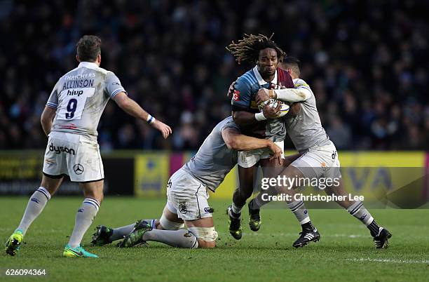 Marland Yard is tackled by Tom Ellis and Dan Bowden of Bath during the Aviva Premiership match between Harlequins and Bath Rugby at Twickenham Stoop...