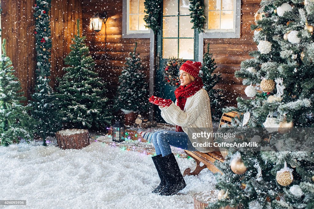 Beautiful woman sitting near her house