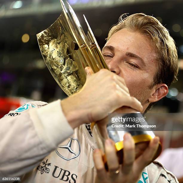 Nico Rosberg of Germany and Mercedes GP kisses his second place trophy after securing the F1 World Drivers Championship during the Abu Dhabi Formula...