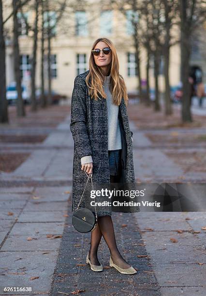 Sofia Grau wearing a black plaid checked Urban Outfitters wool coat, a white creme &other stories jumper, a black h&m pvc mini skirt, black net...