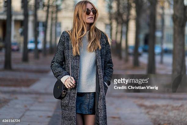 Sofia Grau wearing a black plaid checked Urban Outfitters wool coat, a white creme &other stories jumper, a black h&m pvc mini skirt, black net...