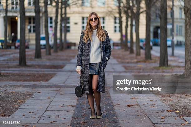 Sofia Grau wearing a black plaid checked Urban Outfitters wool coat, a white creme &other stories jumper, a black h&m pvc mini skirt, black net...