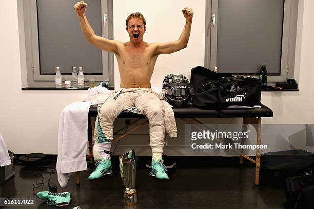 Nico Rosberg of Germany and Mercedes GP celebrates after finishing in second position and securing the F1 World Drivers Campionship in his changing...