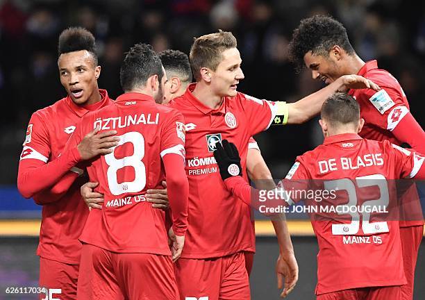 Mainz's Aaron Seydel celebrates scoring the opening goal with teammates during the German first division Bundesliga football match between Hertha BSC...