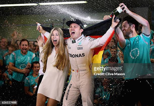 Nico Rosberg of Germany and Mercedes GP celebrates with his wife Vivian Sibold and his team after finishing second and securing the F1 World Drivers...