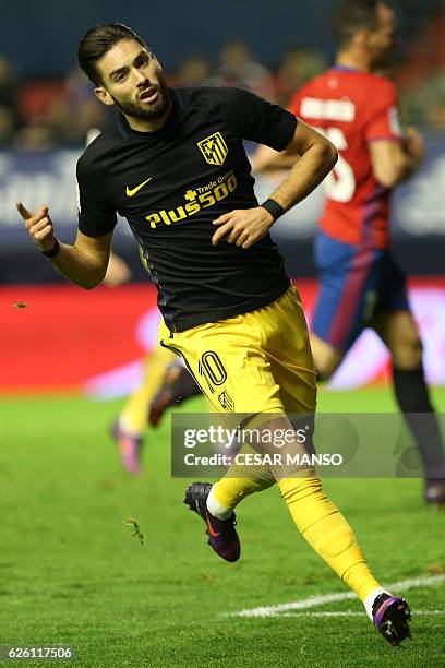 Atletico Madrid's Belgian midfielder Yannick Ferreira Carrasco celebrates after scoring during the Spanish league football match CA Osasuna vs Club...