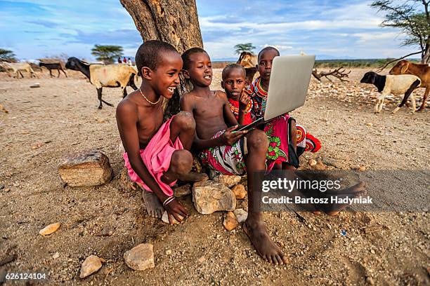 group of african children using laptop, kenya, east africa - third world stock pictures, royalty-free photos & images