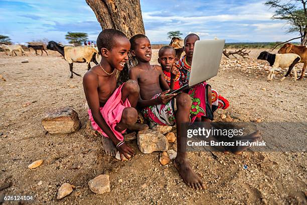 group of african children using laptop, kenya, east africa - kenyan culture stock pictures, royalty-free photos & images