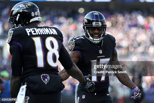 Wide receiver Breshad Perriman of the Baltimore Ravens celebrates with teammate wide receiver Mike Wallace after scoring a first quarter touchdown...