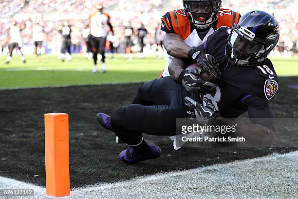 Wide receiver Breshad Perriman of the Baltimore Ravens scores a first quarter touchdown past cornerback Darqueze Dennard of the Cincinnati Bengals at...