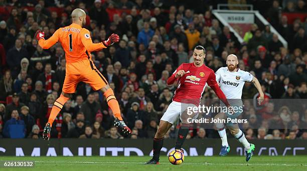 Zlatan Ibrahimovic of Manchester United in action with Darren Randolph of West Ham United during the Premier League match between Manchester United...