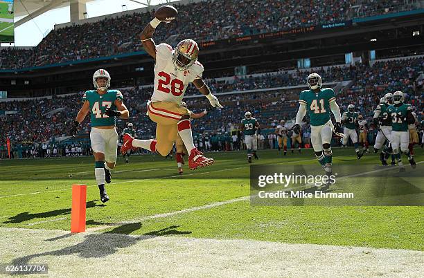 Carlos Hyde of the San Francisco 49ers scores a touchdown during a game against the Miami Dolphins on November 27, 2016 in Miami Gardens, Florida.