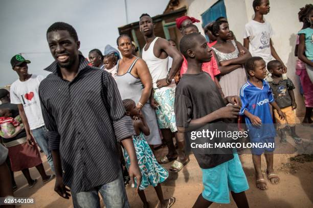 Sympathisers of incumbent president Yahya Jammeh look on as a brief confrontation took place with supporters of Adama Barrow, the flag-bearer of the...