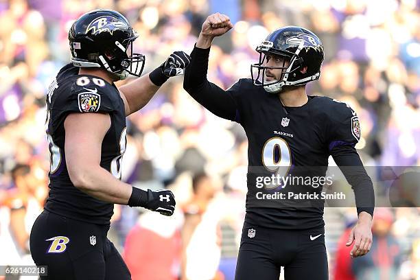 Kicker Justin Tucker of the Baltimore Ravens celebrates with teammate tight end Nick Boyle after kicking a second quarter field goal against the...