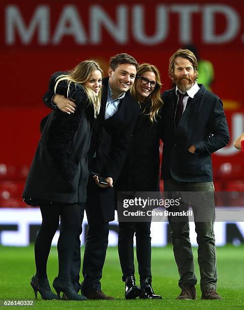 Actress Julia Roberts and husband Danny Moder pose on the pitch after the Premier League match between Manchester United and West Ham United at Old...