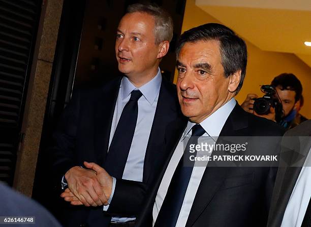 Winner of the right-wing primaries ahead of France's 2017 presidential elections, Francois Fillon shakes hands with Bruno Le Maire, French right-wing...