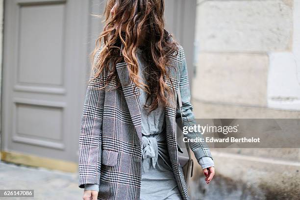 Sofya Benzakour , is wearing a Tobi dress, an H&M black and white coat, Adidas shoes, and a Nakd Fashion gray bag, on November 27, 2016 in Paris,...
