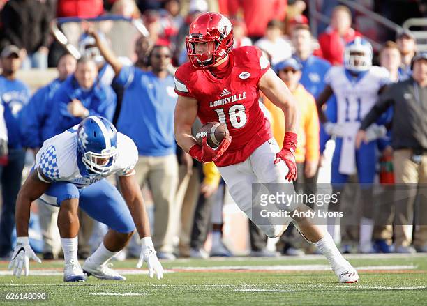 Cole Hikutini of the Louisville Cardinals runs with the ball during the game against the Kentucky Wildcats at Papa John's Cardinal Stadium on...