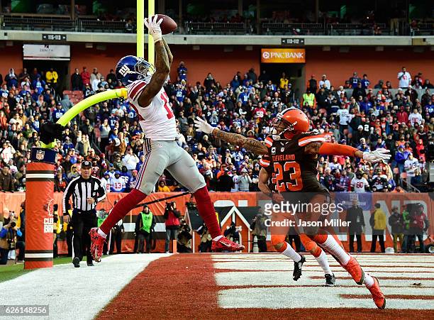 Odell Beckham of the New York Giants can't make a catch inbounds in front of the defense of Joe Haden of the Cleveland Browns during the fourth...