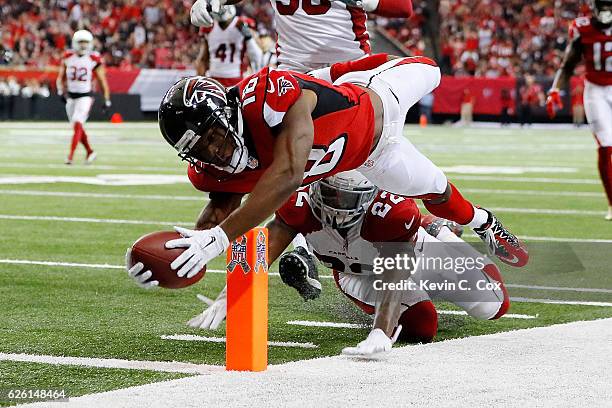 Taylor Gabriel of the Atlanta Falcons dives for the pylon past Tony Jefferson of the Arizona Cardinals to score a touchdown during the second half at...