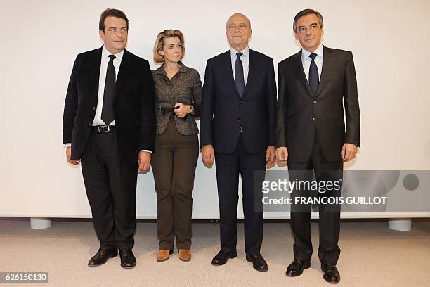 Winner of the right-wing primaries ahead of France's 2017 presidential elections, Francois Fillon , flanked by defeated candidate Alain Juppe,...