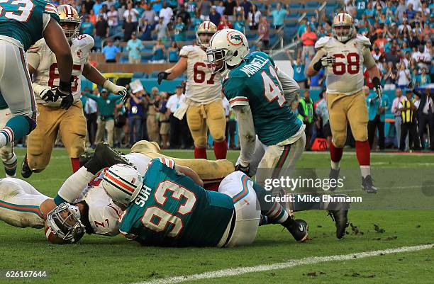 Ndamukong Suh of the Miami Dolphins stops Colin Kaepernick of the San Francisco 49ers on the final play of a game on November 27, 2016 in Miami...