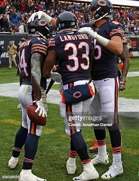 Deonte Thompson of the Chicago Bears is congratulated by Jeremy Langford and Daniel Brown after scoring a touchdown against the Tennessee Titans at...
