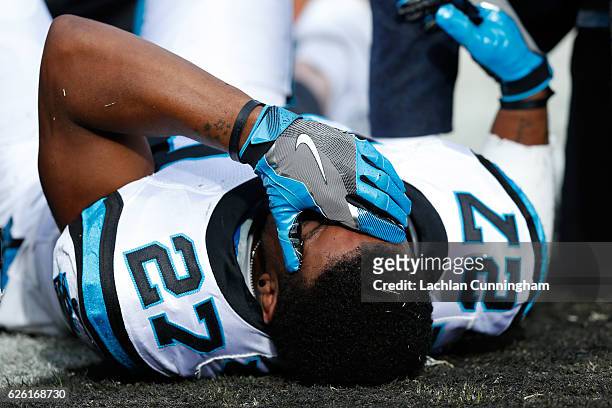 Robert McClain of the Carolina Panthers lays on the field after being injured on touchdown catch by Seth Roberts of the Oakland Raiders during their...