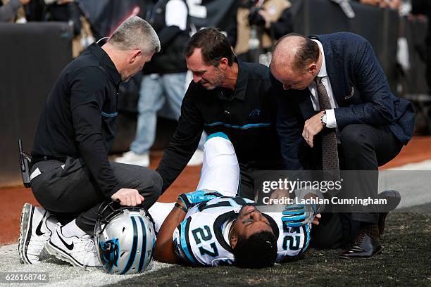 Robert McClain of the Carolina Panthers lays on the field after being injured on touchdown catch by Seth Roberts of the Oakland Raiders during their...