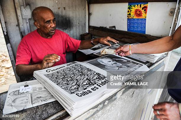 Man sells newspapers in Havana, on November 27 two days after Cuban revolutionary leader Fidel Castro died. Cuban revolutionary icon Fidel Castro...