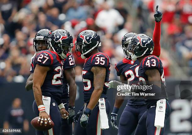 Quintin Demps of the Houston Texans and Eddie Pleasant of the Houston Texans celebrate after an interception in the third quarter at NRG Stadium on...