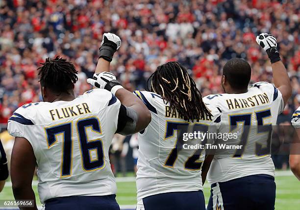 Fluker, Joe Barksdale, and Chris Hairston of the San Diego Chargers raise their fists during the National Anthem before the game against the Houston...