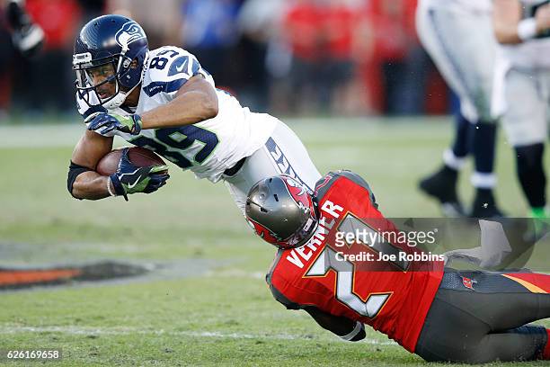 Alterraun Verner of the Tampa Bay Buccaneers tackles Doug Baldwin of the Seattle Seahawks in the second quarter of the game at Raymond James Stadium...